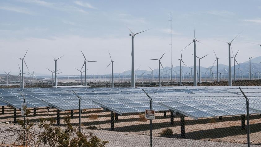 Solar and wind installation representing renewable energy projects.